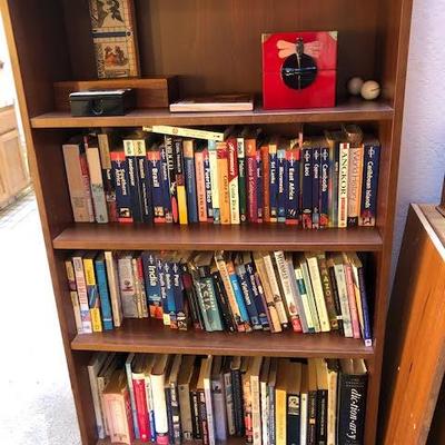 Tall Bookshelf with Assorted Books and Decor Items