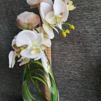 Clear vase with faux Orchids flowers