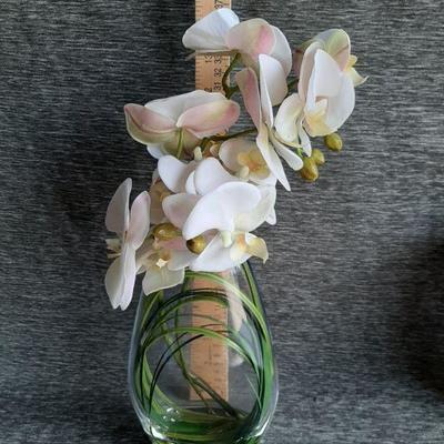 Clear vase with faux Orchids flowers