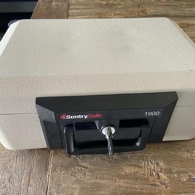 SENTRY SAFE WITH FOB KEY for photos, cash, passports, documents.