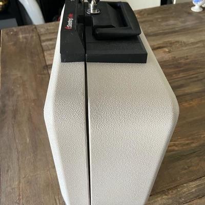 SENTRY SAFE WITH FOB KEY for photos, cash, passports, documents.