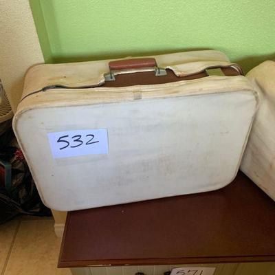 Lot 532. Vintage suitcases with suitcase covers