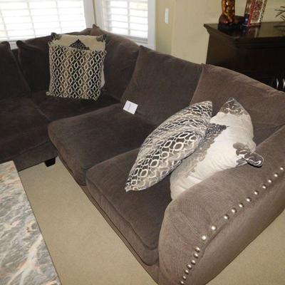Lot 1 dark gray sectional sofa with four decorative pillows