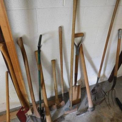 Collection of Garden and Farm Hand Tools Including Pitch Fork, 2 Sided Ax, Bush Whackers, ETC.