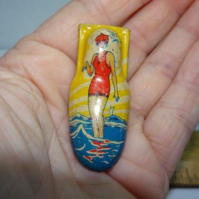 Tin Litho Party Clicker Noisemaker Girl Swimmer Catching a Wave 