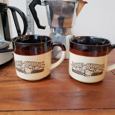 Lot 17: Braun Coffee Maker, Mid Century Italian Moka Express, 2 Rise and Shine Homemade Biscuits Coffee Mugs