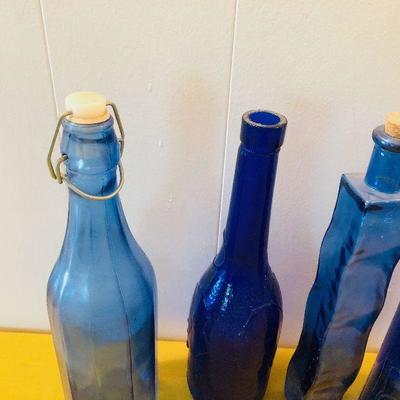 #148 4 blue glass bottles 