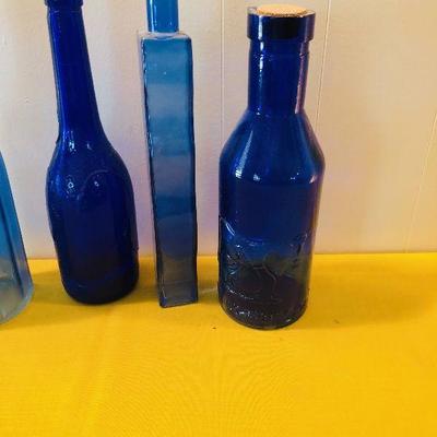 #148 4 blue glass bottles 