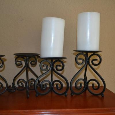 Lot 14. Four metal candle holders and two candles