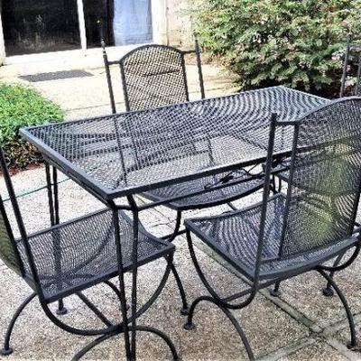 Lot #160  Cast Iron Patio Set - Table and Four Chairs