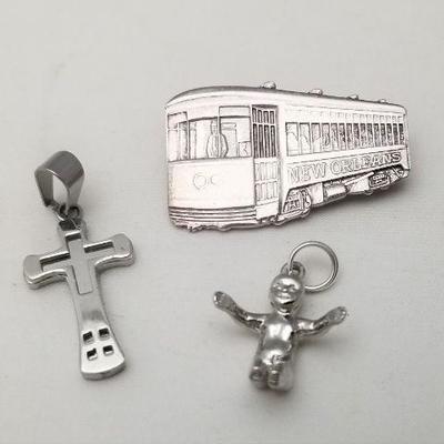 Lot #229  Sterling Streetcar Brooch and King Cake Baby, and Stainless Cross Pendant
