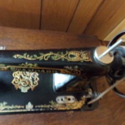H-10  ANTIQUE TREADLE SEWING MACHINE IN CABINET