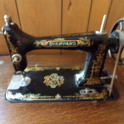 H-10  ANTIQUE TREADLE SEWING MACHINE IN CABINET