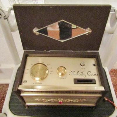 H-64  HEADPHONES, CORDLESS PHONES, MUSICAL COIN BANK AND MORE