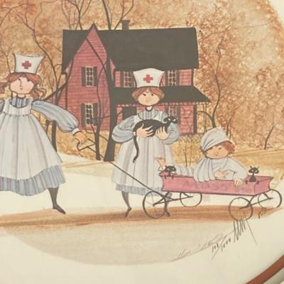 1985 Two Nurses with their patient in a red wagon and lots of black cats -  framed by P. Buckley Moss, limited and signed #108/1000