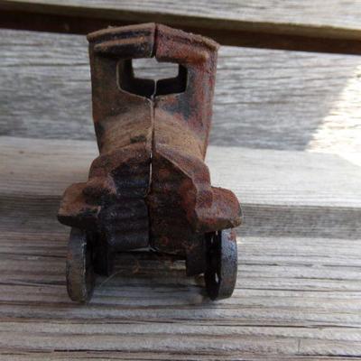 LOT 219  CAST IRON FRUIT CART AND CAR TOYS