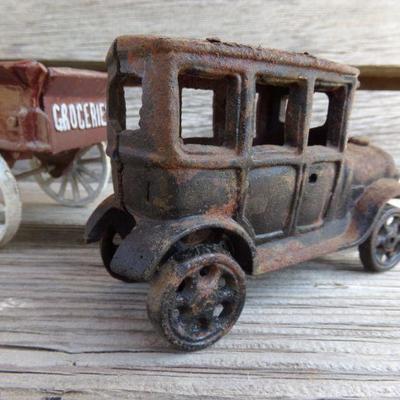 LOT 219  CAST IRON FRUIT CART AND CAR TOYS
