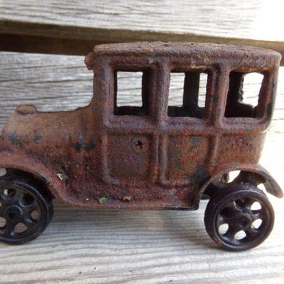 LOT 219  CAST IRON FRUIT CART AND CAR TOYS