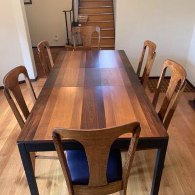 1.  Laminated wood dining table with two leaves, pads and 6 oak chairs
