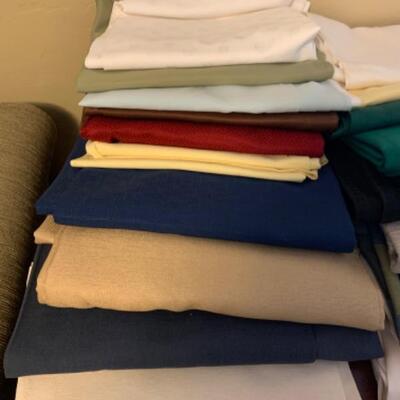 15. Large collection (18 pieces) of table linens (up to 108” in length) in assorted colors and fabrics