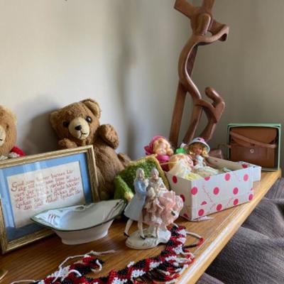 49. Assorted bric-a-brac (figurine, Nancy Ann dolls, wood carving, baby quilt, binoculars, bears, clock, beads, etc.)