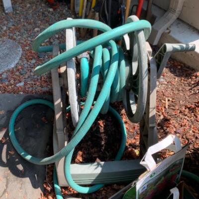 77.  Wheelbarrow, hose, holder, garden drum, bulbs, etc.