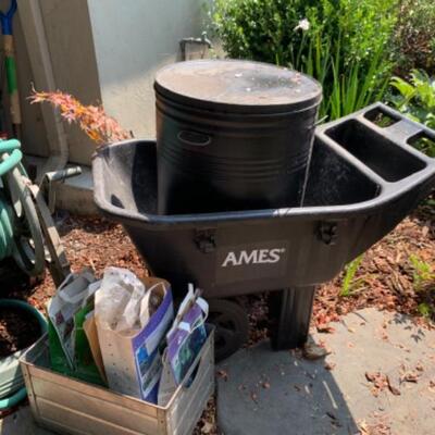 77.  Wheelbarrow, hose, holder, garden drum, bulbs, etc.
