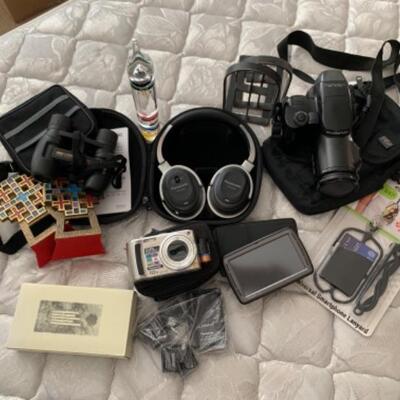 34. Electronics, cameras (Panasonic and Olympus), binoculars, Garmin GPS locator, wind chimes, etc.