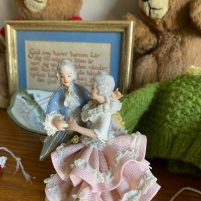 49. Assorted bric-a-brac (figurine, Nancy Ann dolls, wood carving, baby quilt, binoculars, bears, clock, beads, etc.)