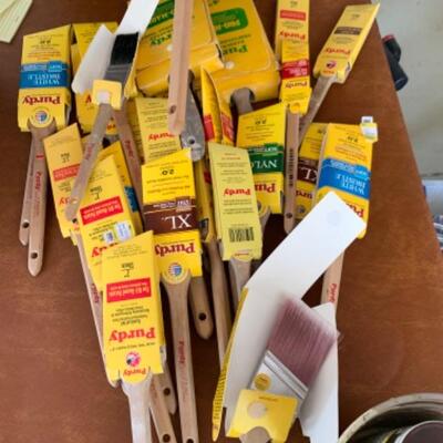 112. Large collection of painting supplies: 25 assorted Purdy brushes (new and used), trays, rollers, disposable foam brushes, caulking...