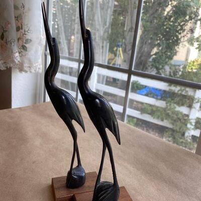 Pair of carved horn on wood base birds