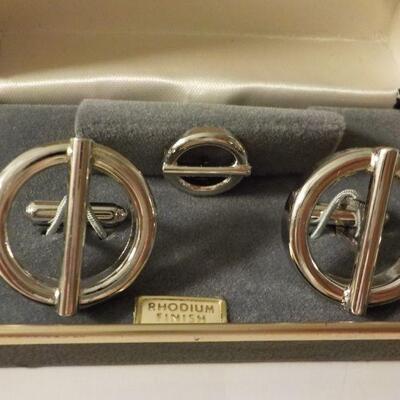2 sets of men's tie clips and cuff links.