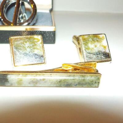 2 sets of men's tie clips and cuff links.