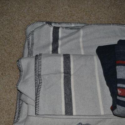 LOT 107. TWO PENDLETON THROW BLANKETS AND ONE PORTUGAL MADE BLANKET