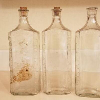 Lot #128: (3) Vintage Large Measuring Impression Glass Bottles