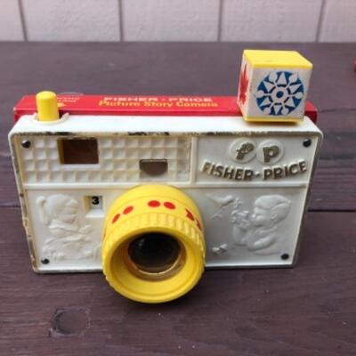Lots 228, 283, 285, 388: Peek-A-Boo Screen: Fisher Price Toys, 1963; Fisher Price Story Camera, 1974;  Fisher Price Pocket Camera , 1967;...