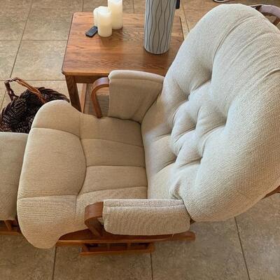 Glider rocker and ottoman with side table and decor 