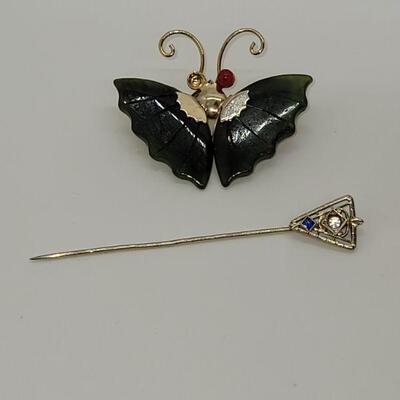 J19: two costume pins a butterfly missing one eye and a stick pin