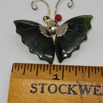 J19: two costume pins a butterfly missing one eye and a stick pin
