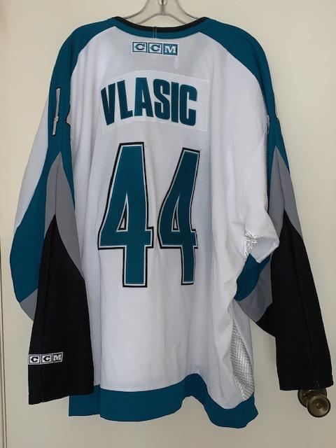 LOT 180 Mark Vlasic Jersey & Autographed Hockey Puck | EstateSales.org