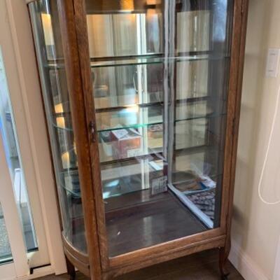 Lot 18. Antique dark oak bow front mirrored display cabinet (36Wâ€x59Hâ€x14,5â€D)--$150