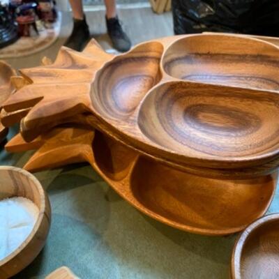 Lot 32. Mid Century Wooden bowls, platters, four letter openers, Hawaiian monkey pod serving bowls, cutting boards, wooden utensils,...