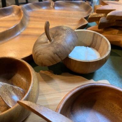 Lot 32. Mid Century Wooden bowls, platters, four letter openers, Hawaiian monkey pod serving bowls, cutting boards, wooden utensils,...
