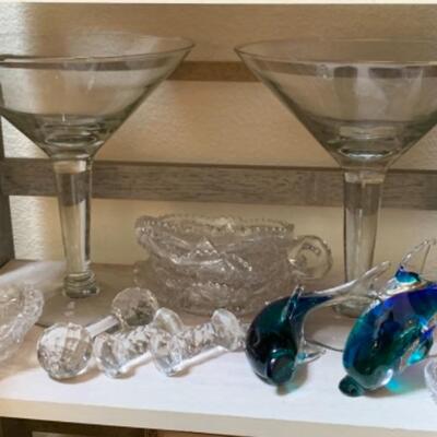 Lot 36. Glass martini pitcher, ice bucket, antique brass scale, shell, large martini glasses, desk clocks, framed Turkish art,...