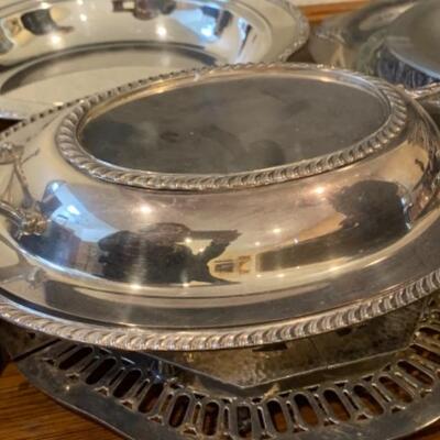 Lot 40. Large assortment of silver plateâ€”serving flatware, carving sets, serving trays, vase, butter dish, creamer, trivets, Selandia...