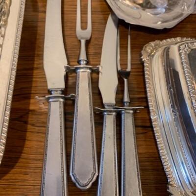 Lot 40. Large assortment of silver plateâ€”serving flatware, carving sets, serving trays, vase, butter dish, creamer, trivets, Selandia...