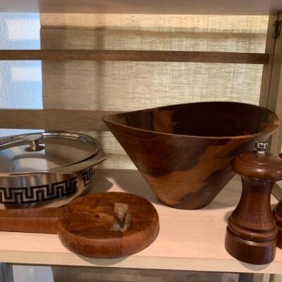 Lot 43. Assortment of mid-century wooden service pieces, stainless steel, chargers (8), wooden salad bowl, salt and pepper set with...