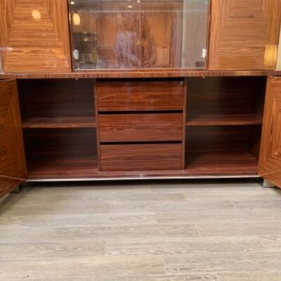 Lot 49. Amazing Giorgio Collection lighted breakfront, whisky colored with geometric design, glass doors and chrome fixtures.  Total...