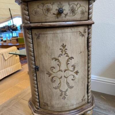 Lot 57. Oval side cabinet of distressed bleached wood--$35