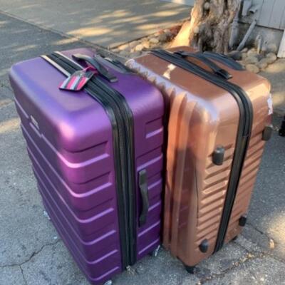 Lot 103. Two hard case suitcasesâ€”one London Fog, the other Constellation (with minor damage)--$35